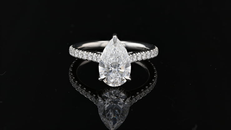 Pear shape diamond set in pave setting with a diamond pave hidden halo